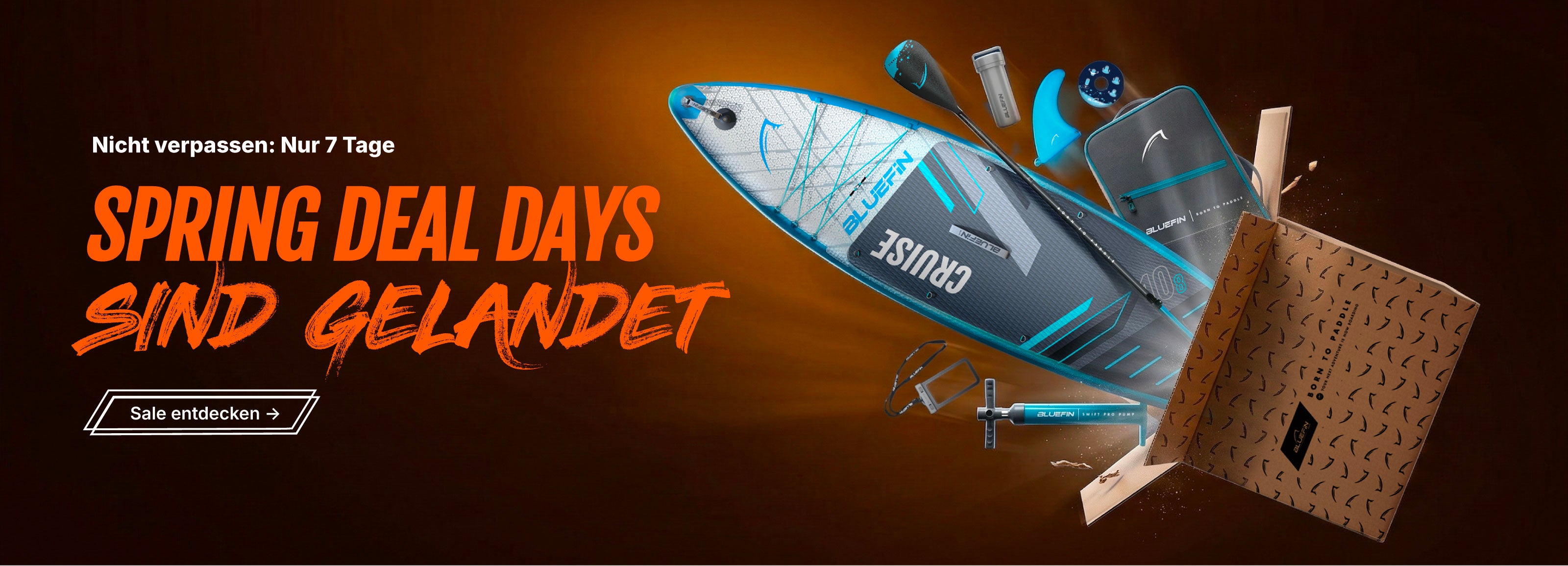 Inflatable paddleboard with blue and gray design, paddle, pump, and accessories in a box