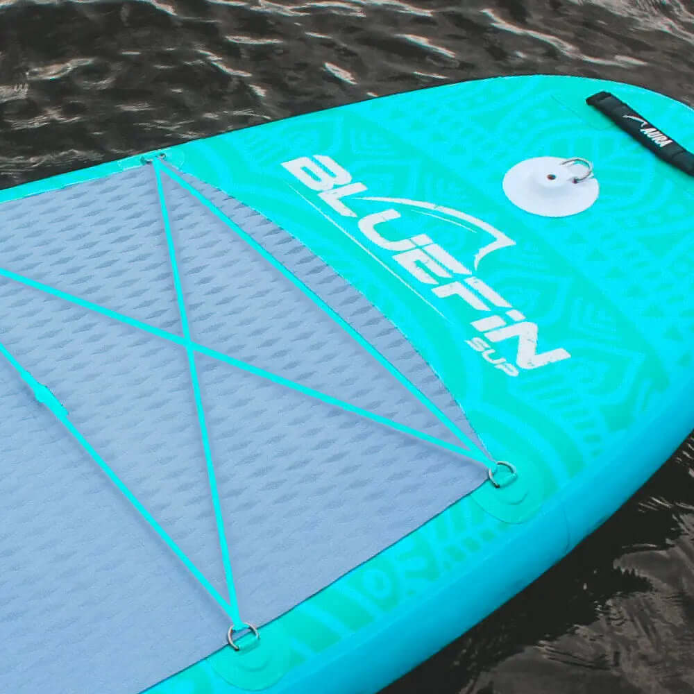 Inflatable paddleboard in turquoise with textured deck pad and bungee cord storage system