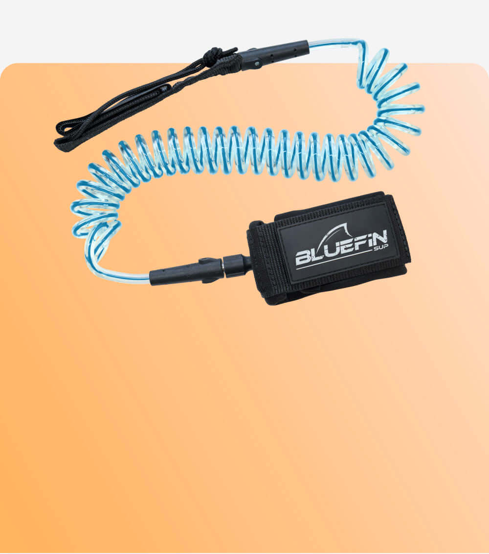 Coiled safety leash with black strap and blue cord, featuring a BLUEFIN SUP logo on the attachment