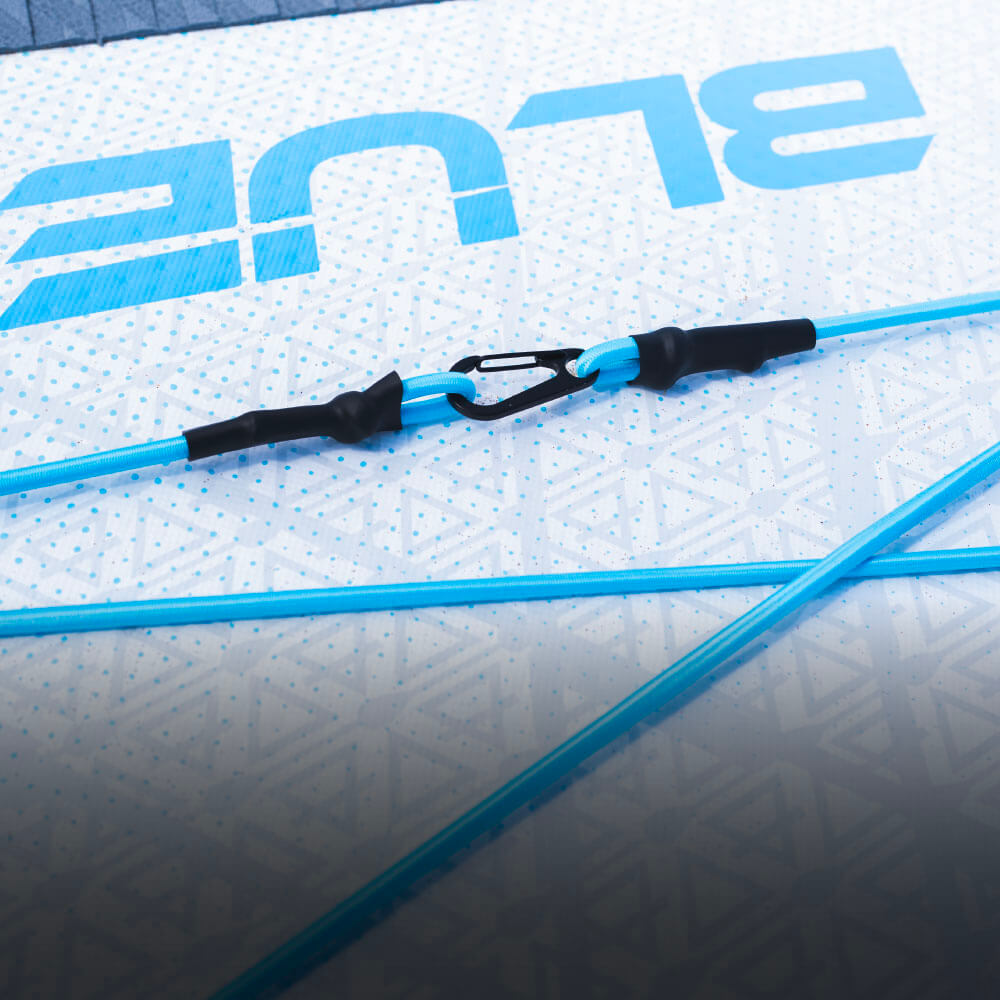 Blue paddleboard bungee cord with clips on a textured white deck pad