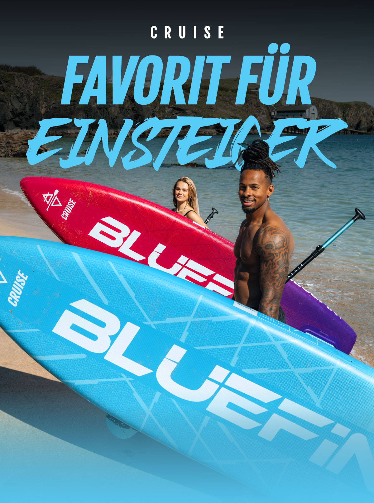 Two inflatable paddleboards in blue and red on a beach, with two people holding paddles behind them.