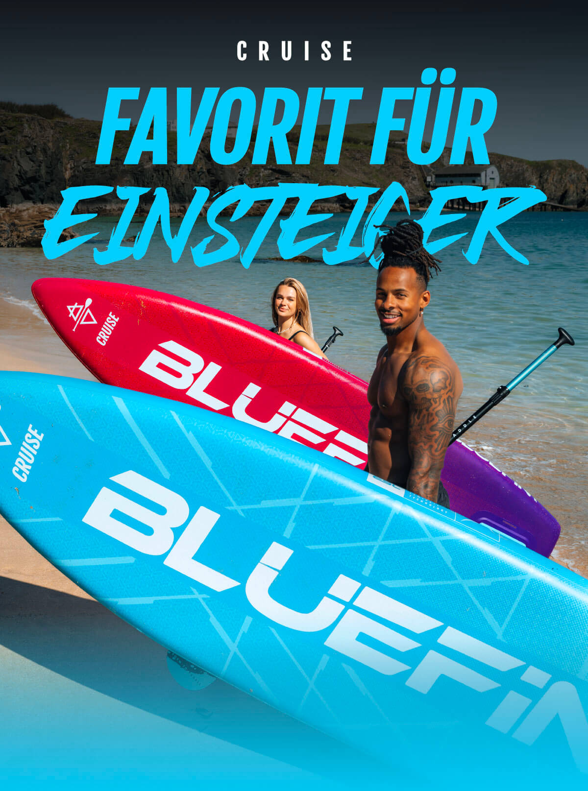Two inflatable paddleboards in blue and red on a beach, with two people holding paddles behind them.