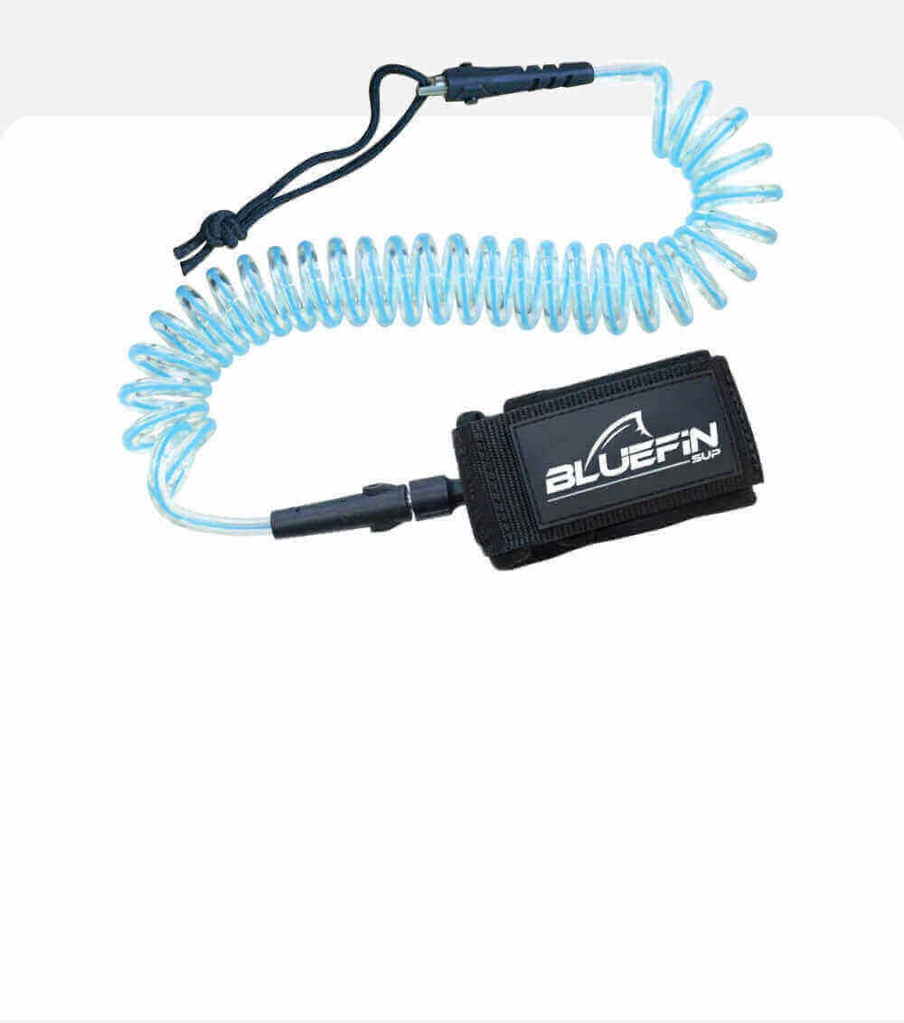 Coiled safety leash with a black strap and blue elastic cord for paddleboarding