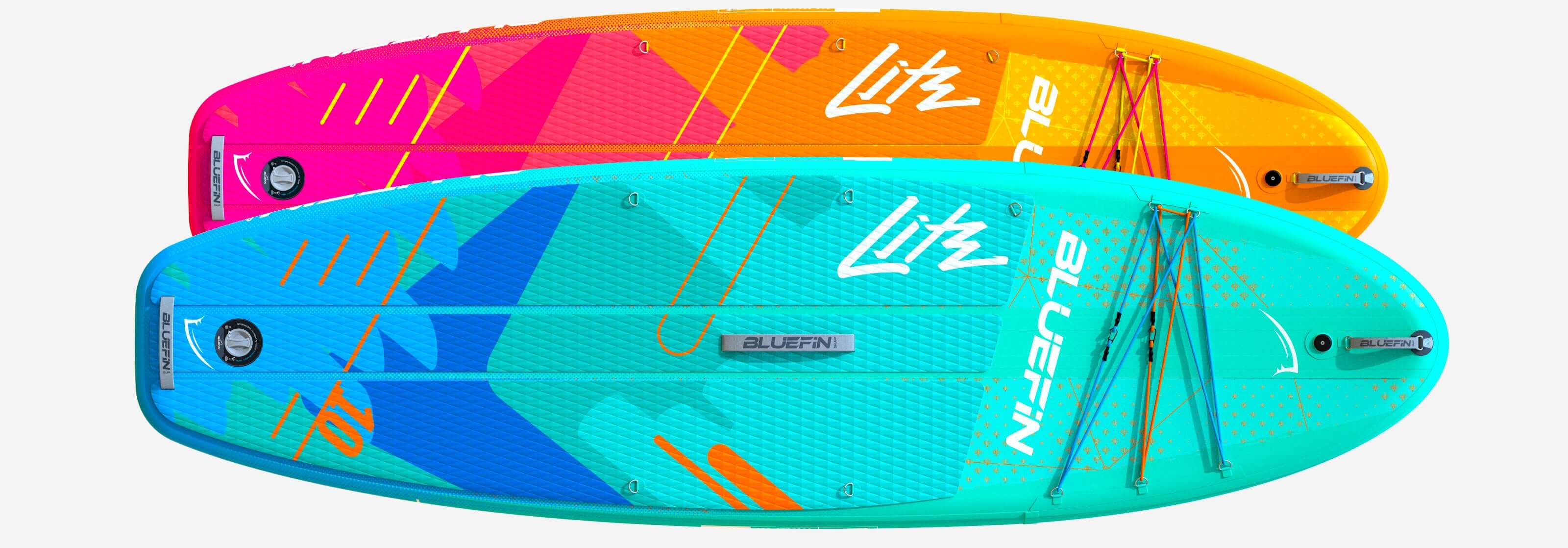 Two inflatable paddleboards in bright colors, one pink and blue, the other teal and orange, with textured decks.