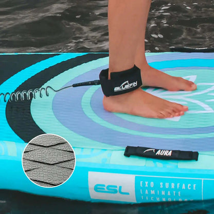 Person standing on a blue inflatable paddleboard with a leash and textured deck pad